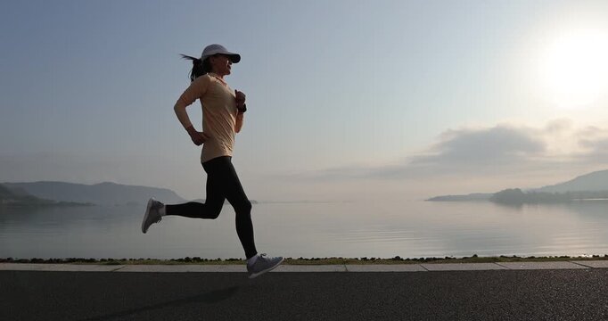 Fitness woman runner running at seaside