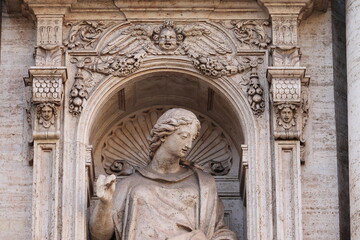 Fototapeta premium Statue of Saint Felicity on the Facade of the Santa Susanna alle Terme di Diocleziano Church in Rome, Italy