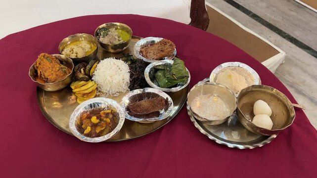 Bengali traditional dishes with Bhetki paturi, Katla Fish, fish fingers, Sukta Posto, rosogolla, paes