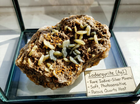 Pale yellow iodargyrite crystals on an oxidized gossan matrix.