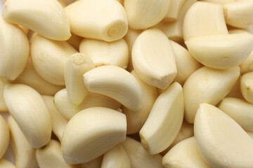 Fresh peeled garlic cloves as background, closeup
