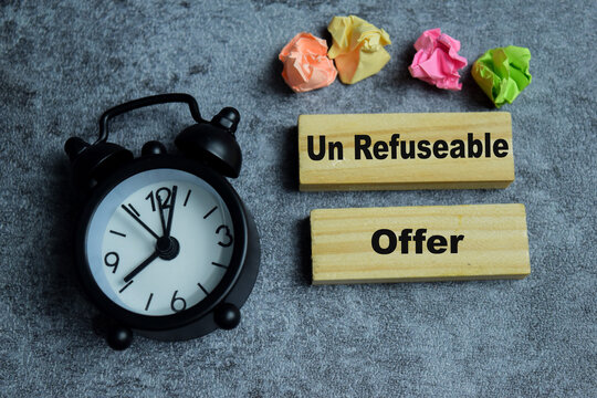 Concept of text un refuseable offer on wooden blocks. Represented professional business leadership and operations