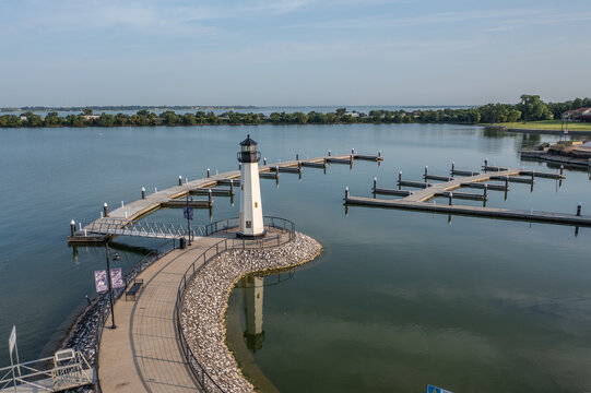 Lighthouse On Boat Dock Along Clear Blue Lake of Rockwall Harbor With City of Rockwall, Texas in the Distance