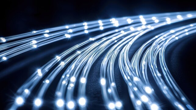 Curved cable macro displaying bundled fiber optic cables with glowing light trails showcasing cable density and professional installation routing characteristics