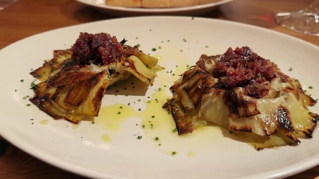Roasted Artichokes with Serrano Ham and Marcona Almonds. Delicious perfect snack. High quality 4k footage