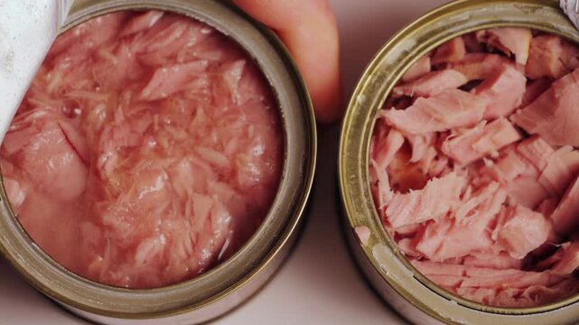 Hand opening a can of fish, concept of seafood. High quality 4k footage