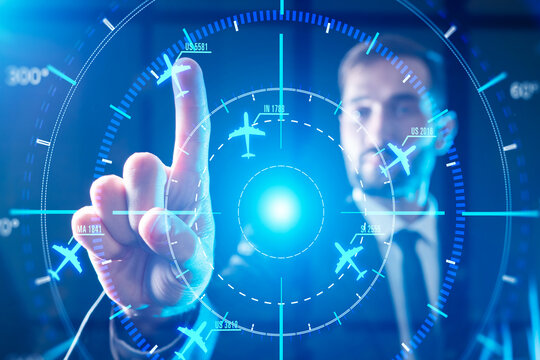 Airline dispatching, flight management and air traffic coordination. Aviation controller interacts with digital radar interface, directing airline routes, monitoring departures organizing global 