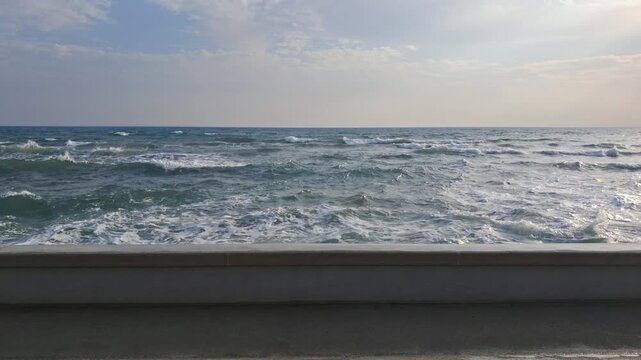 Waves crashing against the promenade seawall of Larnaca, Cyprus.