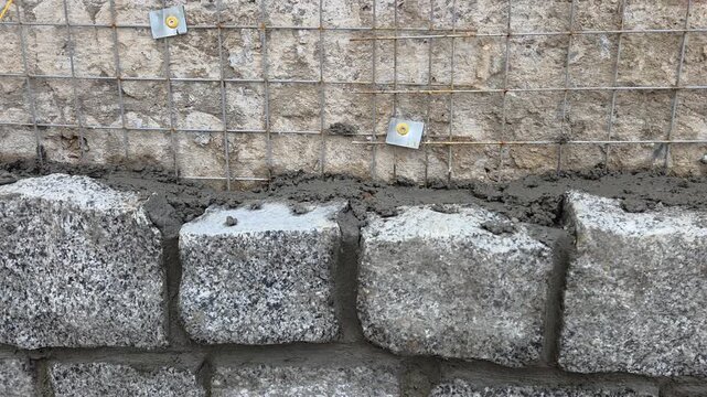 Granite Stone Blocks Laying Cement Mortar Retaining Wall Reinforcement Mesh Construction Site Masonry