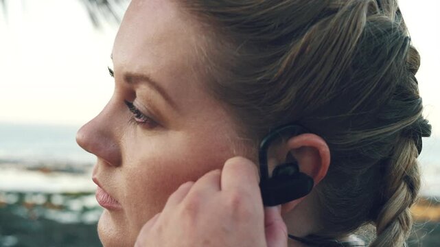 Break, earphones and fitness with woman on beach for recovery or rest from training fatigue, Exercise, thinking and tired with exhausted runner outdoor for health, cardio workout or wellness