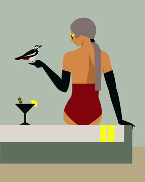 Woman sitting on towel holding a woodpecker with cocktail nearby