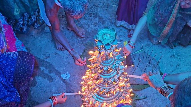 Top view of women lighting diyas together during an Indian festival, creating a beautiful circle of glowing flames. Dushara, Vijayadashami, Diwali celebration, spirituality, community bonding, and fes