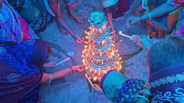 Top view of women lighting diyas together during an Indian festival, creating a beautiful circle of glowing flames. Dushara, Vijayadashami, Diwali celebration, spirituality, community bonding, and fes