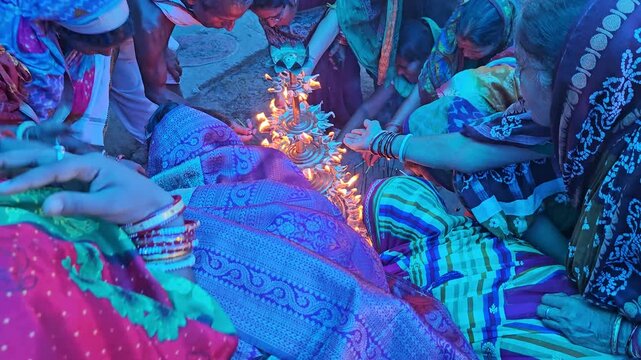 Top view of women lighting diyas together during an Indian festival, creating a beautiful circle of glowing flames. Dushara, Vijayadashami, Diwali celebration, spirituality, community bonding, and fes