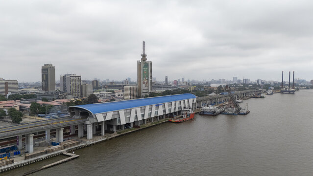 Lagos, Nigeria - 02 August 2025: Aerial view of the Lagos Blue Line Rail Mass Transit, a beacon of progress against the backdrop of the city's skyline and the calm, reflective waters of Lagos Lagoon.