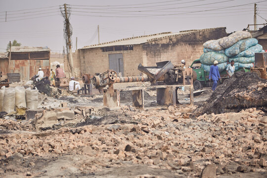 Kano, Nigeria - 27 January 2024: View of the charred remains near Fatima Market, a stark contrast to the sacks piled high on a truck.