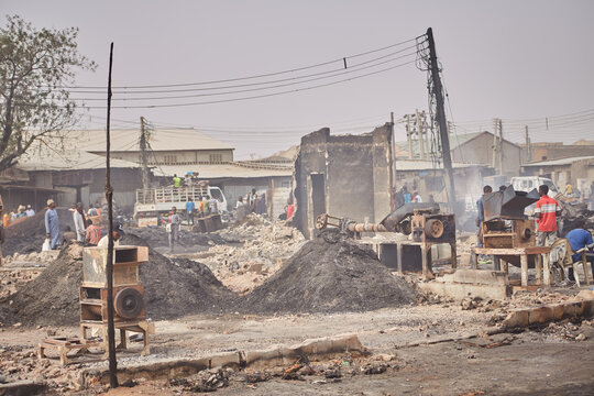 Kano, Nigeria - 27 January 2024: View of the charred ruins and debris at Fatima Market near Dakata fire service, a scene of devastation under a hazy sky.