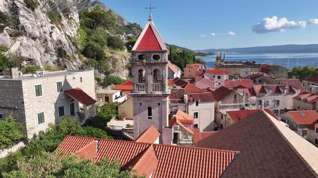 Detailed drone close up of St Michael church bell tower in Omi&scaron; showing architectural features and historic structure in old town Dalmatia Croatia