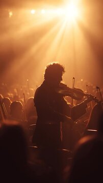 Cinematic concert violinist silhouette holding violin under a strong warm golden spotlight. The rest of the orchestra blurred in background