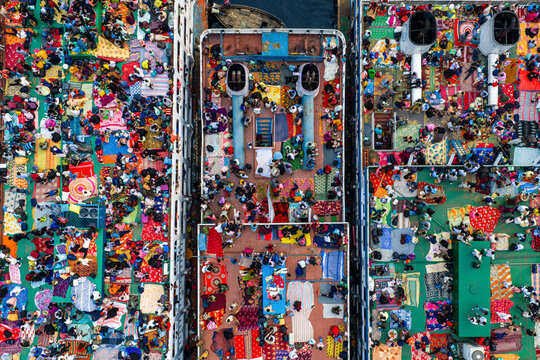 18 March 2026 - Dhaka, Bangladesh: Aerial view of passengers traveling home for Eid at Sadarghat Launch Terminal, resorting to traveling on the rooftops braving discomfort and danger.