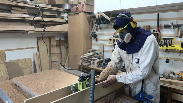 Cinematic Eye Level Shot of Faceless Artisan in Extreme PPE Milling Timber Slab with Router Slow Motion Authentic Workshop B-Roll