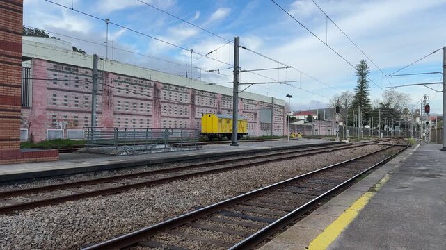 empty railway station platform with tracks and yellow wagon concept of transport, logistics, travel, banner