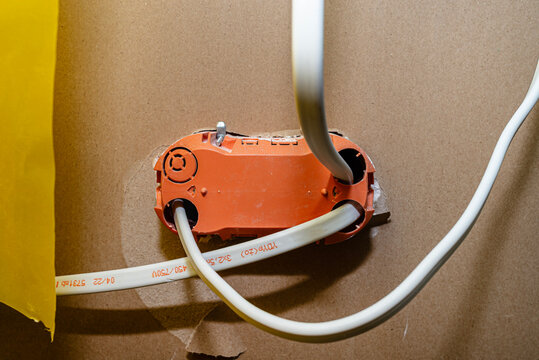 Electrical box with cables on plasterboard wall during renovation