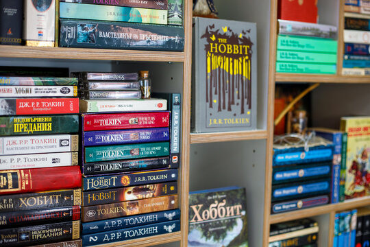 Varna. Bulgaria. 07. 02.2026 large collection of fantasy books by tolkien arranged on wooden bookshelf, colorful editions of hobbit and lord of the rings in cozy interior