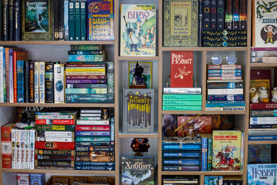Varna. Bulgaria. 07. 02.2026 large collection of fantasy books by tolkien arranged on wooden bookshelf, colorful editions of hobbit and lord of the rings in cozy interior