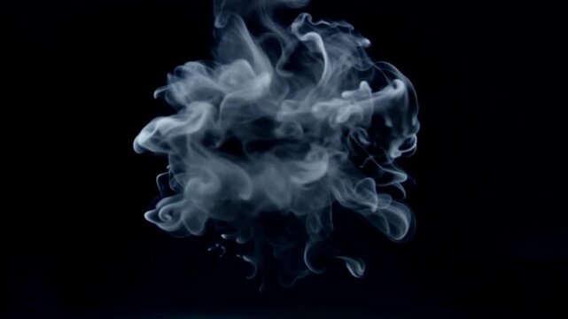 Smoke rising in a dark background for a mysterious and dramatic effect
