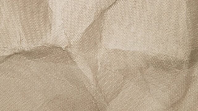 Crumpled recycled brown paper texture with wrinkled surface and organic feel