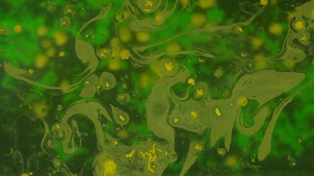 Yellow paint bubbles with green backdrop