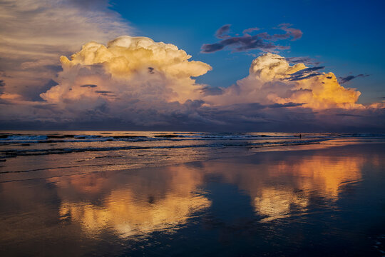Experience the Tranquil Beauty of a Sunset Seascape with Dramatic Cloud Reflections in Florida, New Smyrna Beach, USA