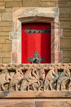 Explore Historic Architecture: Ornate Red Door and Intricate Stone Carvings at Bok Tower Gardens in Lake Wales, Florida, USA