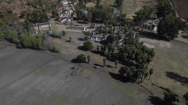 Camera panning up over the historic center of the small historic village of Wupperthal. Wupperthal village is an isolated historical town in Cederberg known for whitewashed thatch roof houses, 4K 