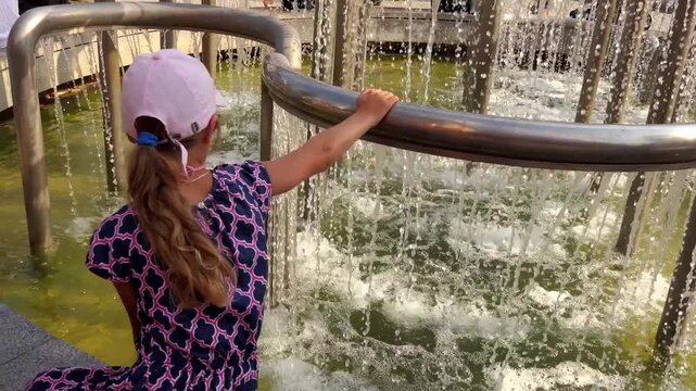 Little girl near the fountain in Miskolc, Hungary.