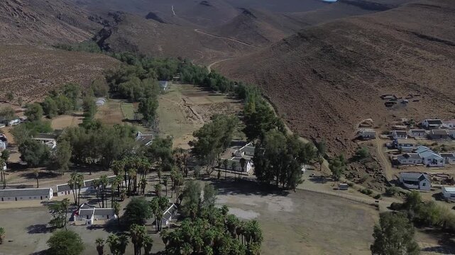 Camera panning left to right over the small historic village of Wupperthal. Wupperthal village is an isolated historical town in Cederberg known for its whitewashed thatch roof houses, 4K Aerial Video