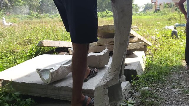 Close-up of a skilled artisan shaping a fibre sculpture using a power tool in a workshop, captured in slow motion. The scene highlights precision craftsmanship, manual labor, India