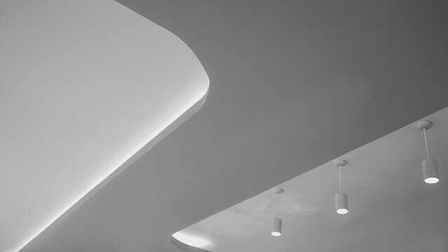 Modern minimalist ceiling with recessed lighting and pendant lamps.