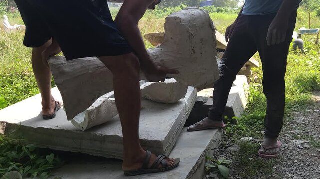 Close-up of a skilled artisan shaping a fibre sculpture using a power tool in a workshop, captured in slow motion. The scene highlights precision craftsmanship, manual labor, India