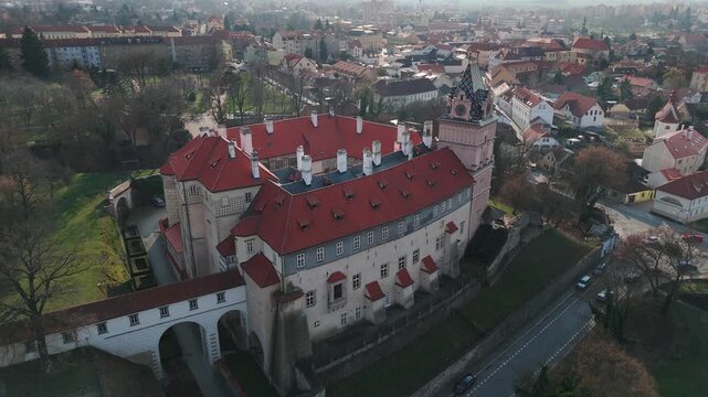 Aerial drone footage slowly approaching Brand&yacute;s nad Labem castle from the front, Czech Republic. The shot reveals the full castle facade with its Renaissance architecture, arched entrance bridge over 