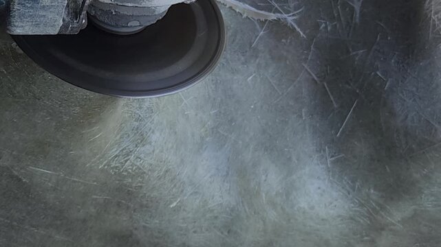 Close-up of a skilled artist using an angle grinder to cut and shape a fibre sculpture, captured in slow motion. The scene highlights precision craftsmanship, manual work, and industrial tools, India
