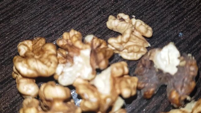 A close-up of the walnut kernel reveals the flavorful, nutrient-rich meat removed from its shell, showcasing its distinctive texture.

