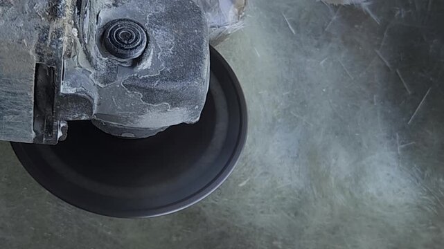 Close-up of a skilled artist using an angle grinder to cut and shape a fibre sculpture, captured in slow motion. The scene highlights precision craftsmanship, manual work, and industrial tools, India