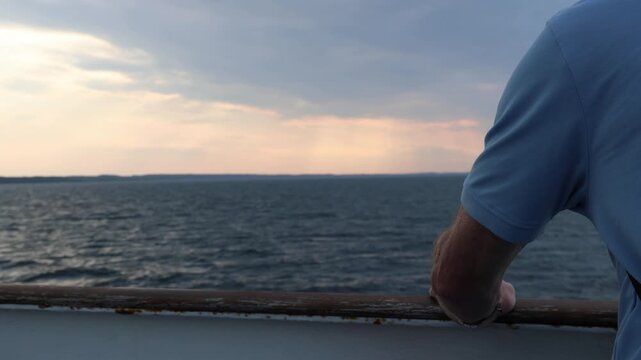 Old man on the boat cruising across the sea, cinematic with dramatic sky