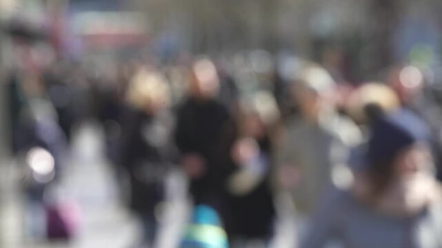 Blurred Crowd of Pedestrians on Sunny Winter Street