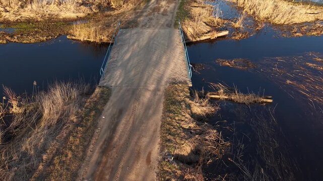 Forward Tilt Down Over Wooden Herringbone Bridge at Golden Hour