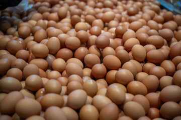 Large pile of brown chicken eggs filling the frame © AnrizStock
