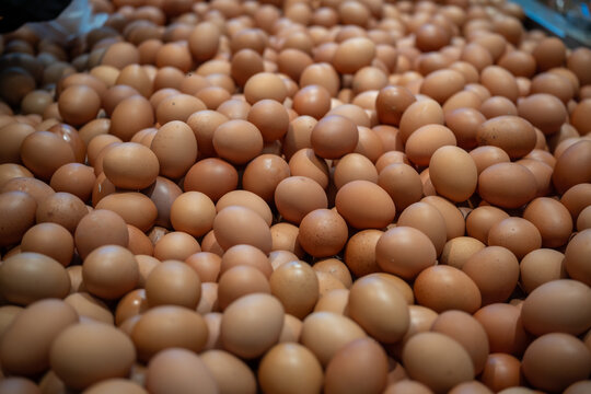 Large pile of brown chicken eggs filling the frame