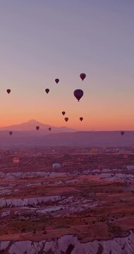 Majestic Hot Air Balloons Soaring Over Cappadocia's Unique Landscape at Golden Sunrise